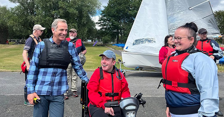 Robson Green and Lost Voice Guy with group of people at Derwent Reservoir © BBC